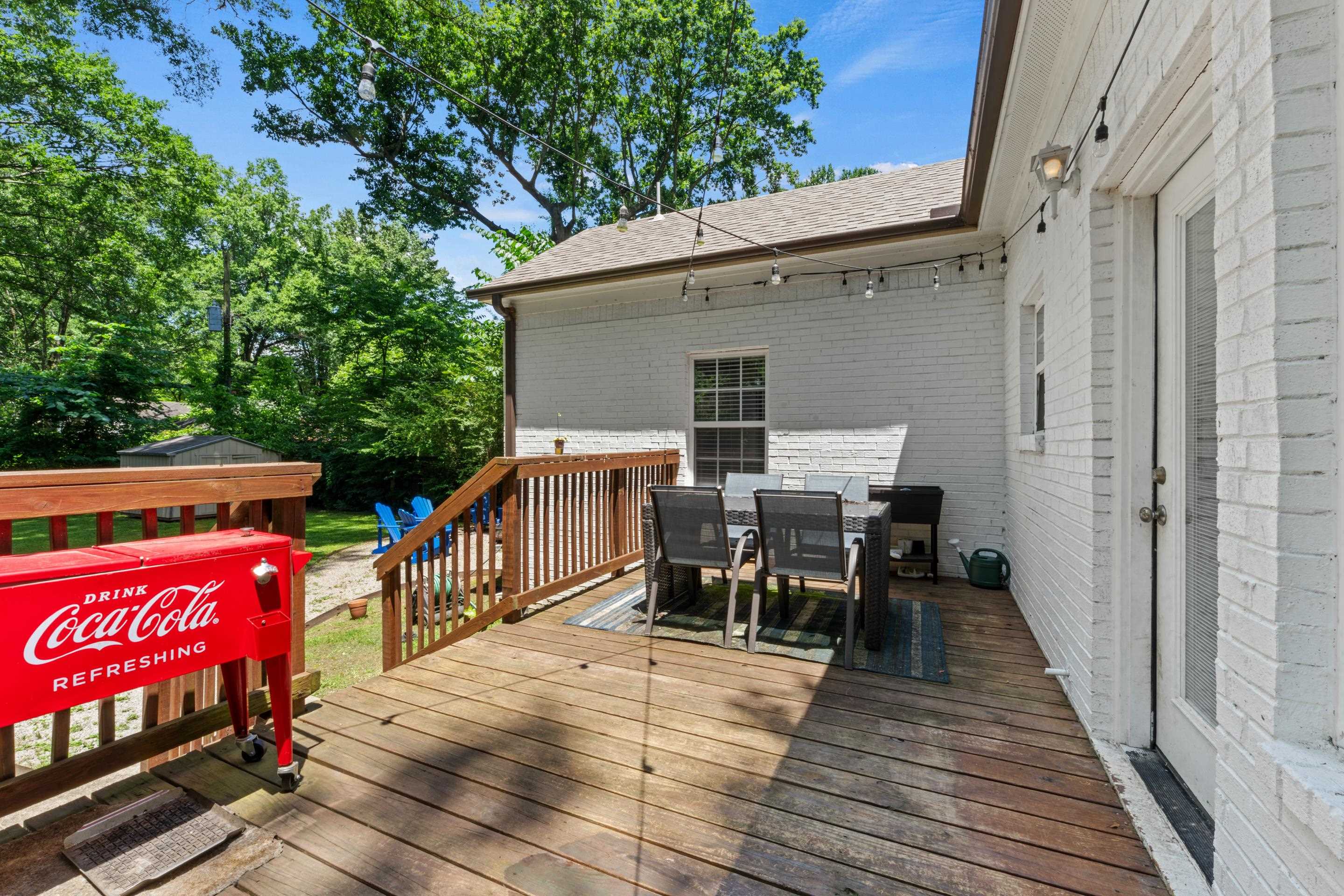 1255 Colonial Road Memphis, TN 38117 - Photo 26 of 30 Expansive wooden deck with railing and stairs to the yard