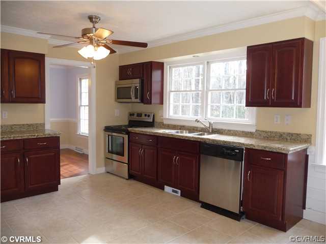 13811 Barnes Spring Road Midlothian, VA 23112 - Photo 2 of 12 a kitchen with granite countertop a stove a sink dishwasher and a microwave oven