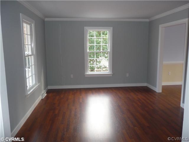 13811 Barnes Spring Road Midlothian, VA 23112 - Photo 6 of 12 a view of an empty room with wooden floor and a window