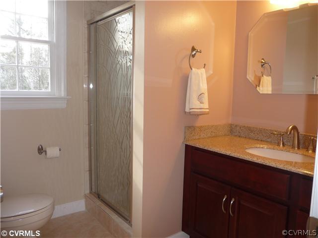 13811 Barnes Spring Road Midlothian, VA 23112 - Photo 8 of 12 a bathroom with a granite countertop sink toilet and mirror