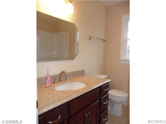 13811 Barnes Spring Road Midlothian, VA 23112 - Photo 10 of 12 a bathroom with a granite countertop sink and a mirror