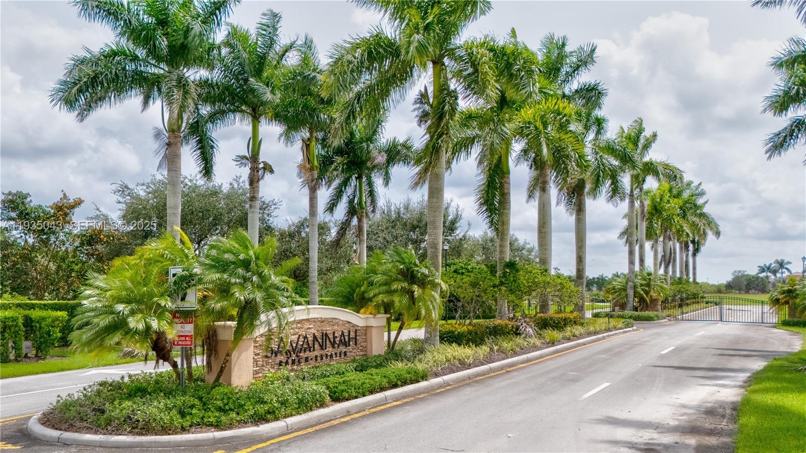 a front view of a house with a yard and palm trees