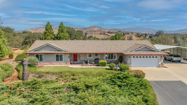 a view of a house with swimming pool and sitting area