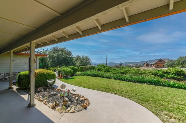 a view of backyard of house with garage