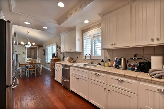 a kitchen with stainless steel appliances a refrigerator and a stove top oven