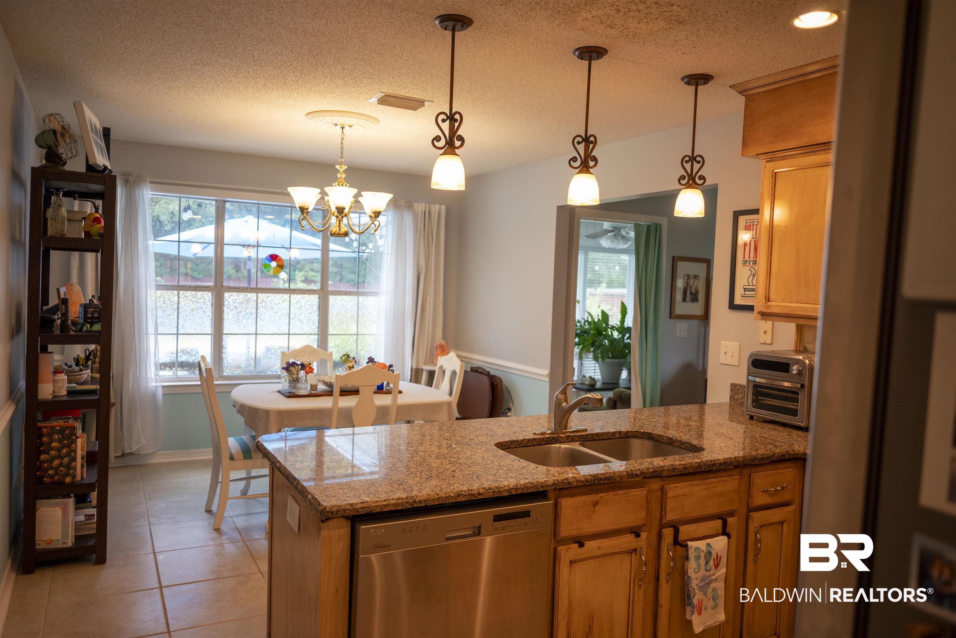 808 Wisteria Lane Foley, AL 36535 - Photo 8 of 19 Kitchen with dishwasher, a textured ceiling, decorative light fixtures, and sink