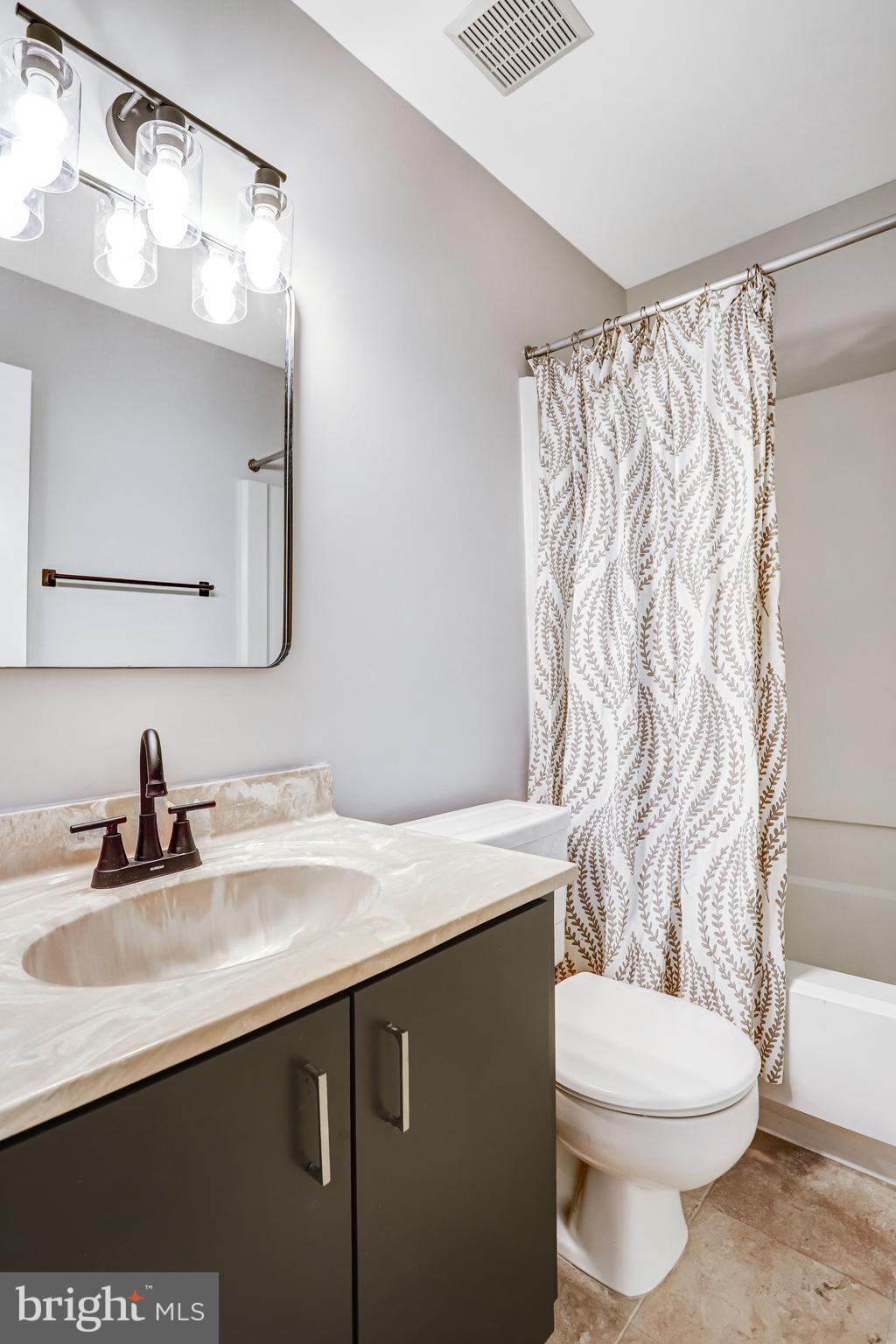 1953 Lakeport Way Reston, VA 20191 - Photo 13 of 60 a bathroom with a granite countertop sink and a mirror