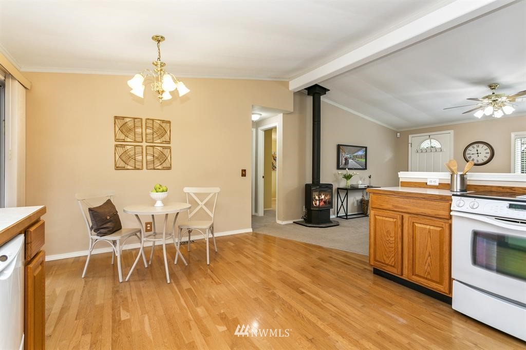 520 North Carpenter Road Snohomish, WA 98290 - Photo 9 of 25 a view of a dining room with furniture a chandelier and wooden floor