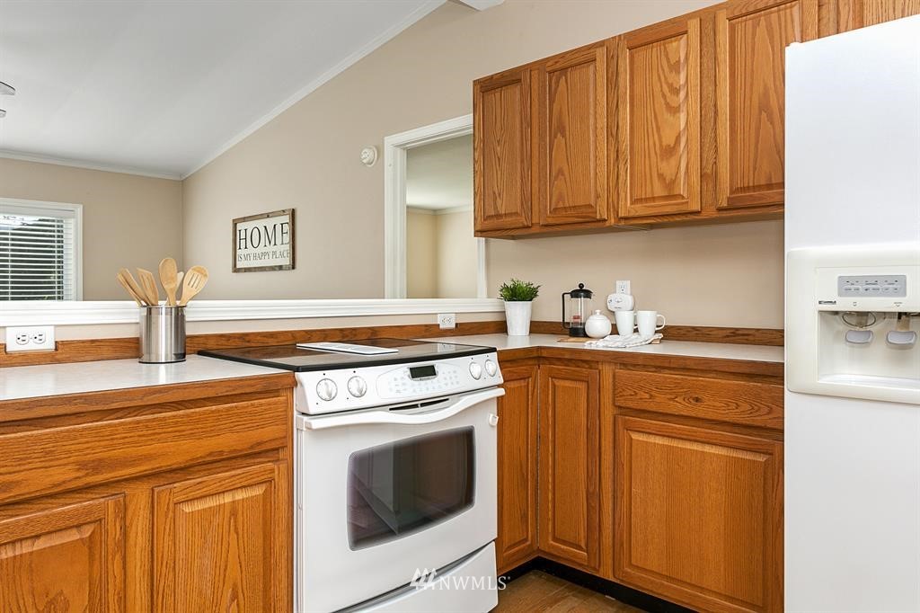 520 North Carpenter Road Snohomish, WA 98290 - Photo 10 of 25 a kitchen with granite countertop cabinets stainless steel appliances and wooden cabinets