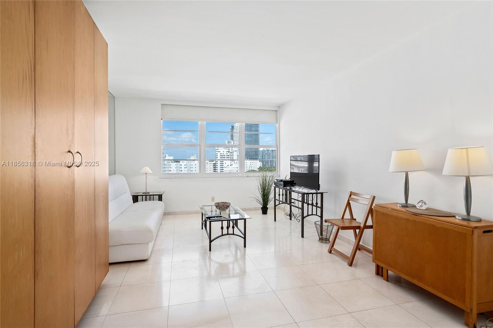 100 Lincoln Road, Unit 1147A Miami Beach, FL 33139 - Photo 2 of 4 a living room with furniture and a lamp