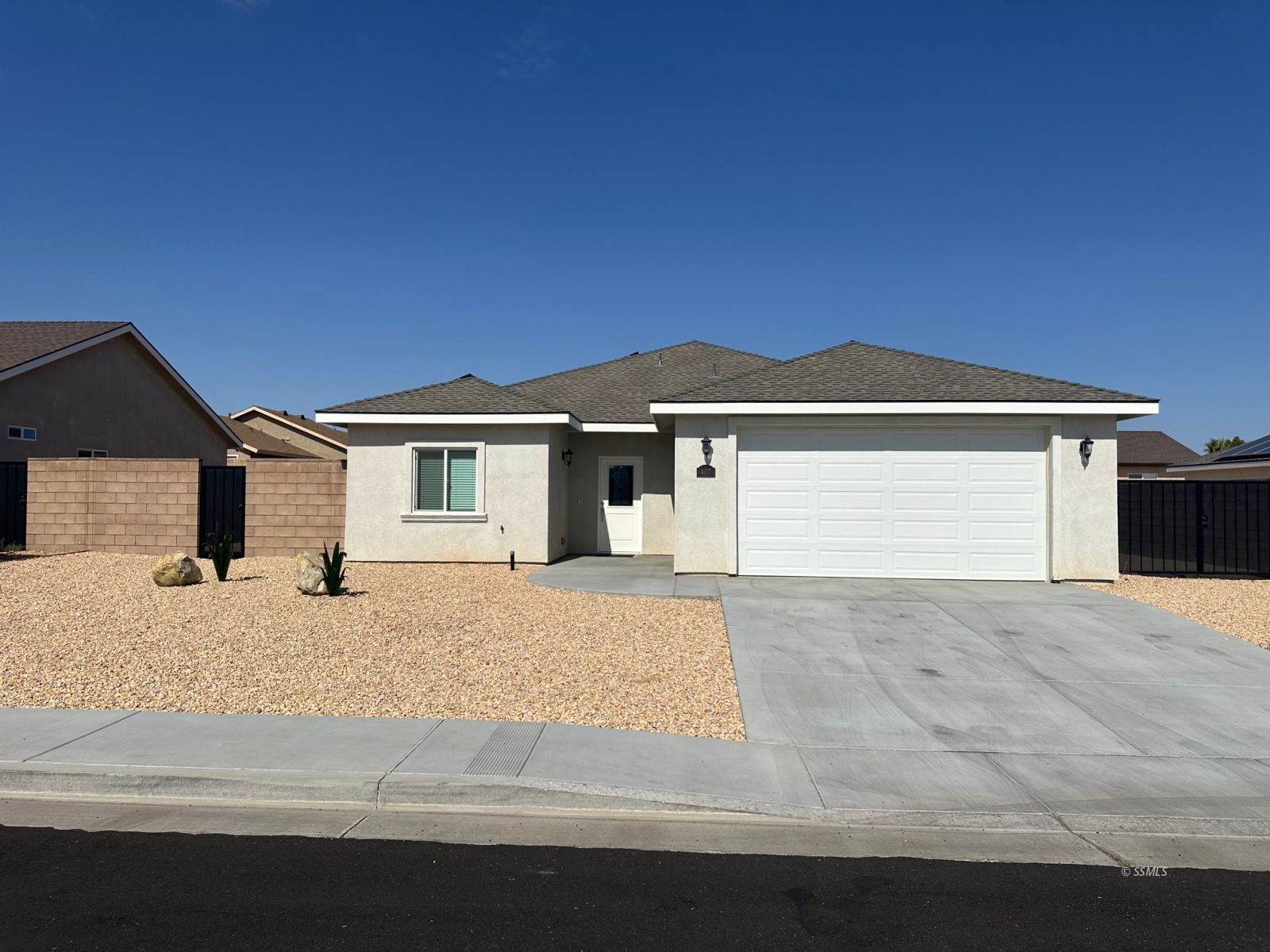 407 Thomas Street Ridgecrest, CA 93555 - Photo 1 of 11 a front view of a house with a yard and garage