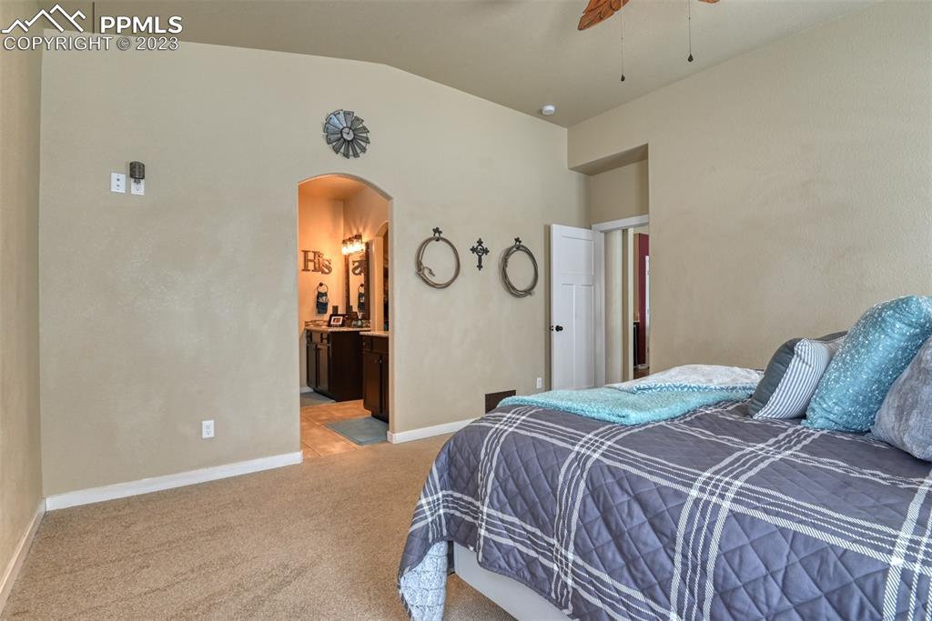 9785 Terrain Road Fountain, CO 80817 - Photo 13 of 40 a bedroom with a bed and a chandelier