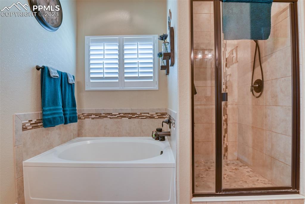 9785 Terrain Road Fountain, CO 80817 - Photo 15 of 40 a white bath tub sitting next to a window
