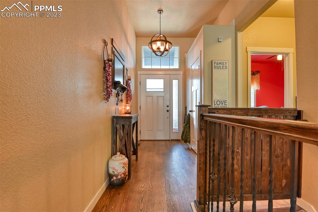 9785 Terrain Road Fountain, CO 80817 - Photo 18 of 40 a view of a hallway with wooden floor and entryway