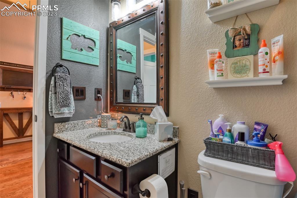 9785 Terrain Road Fountain, CO 80817 - Photo 19 of 40 a bathroom with a granite countertop sink and a mirror
