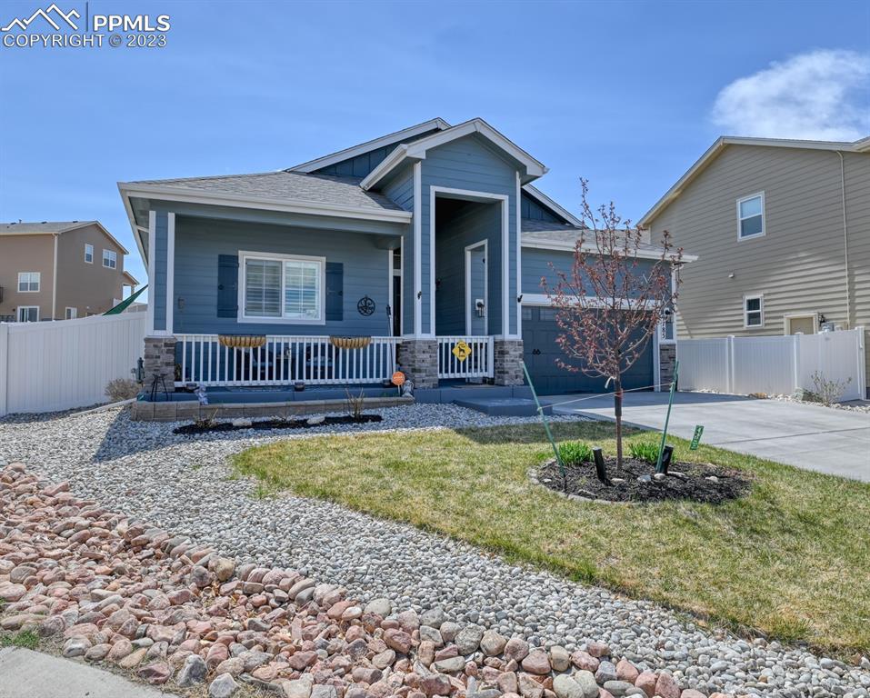 9785 Terrain Road Fountain, CO 80817 - Photo 2 of 40 a front view of a house with garden