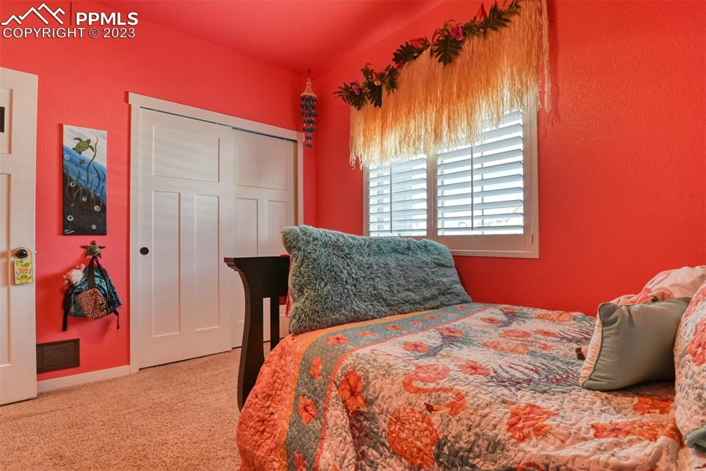 9785 Terrain Road Fountain, CO 80817 - Photo 21 of 40 a bedroom with a bed and a painting on the wall