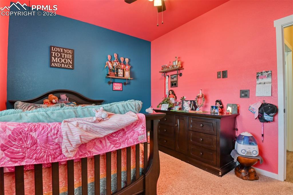 9785 Terrain Road Fountain, CO 80817 - Photo 22 of 40 a bedroom with a bed and a dresser