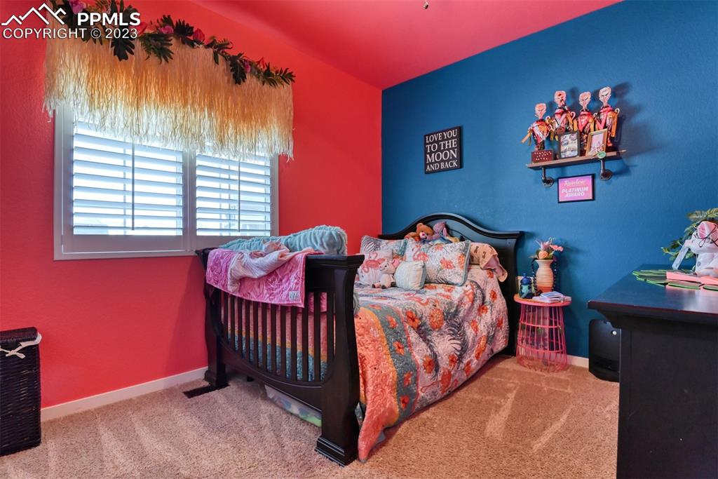 9785 Terrain Road Fountain, CO 80817 - Photo 23 of 40 a bedroom with a bed and a window