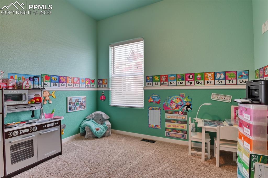 9785 Terrain Road Fountain, CO 80817 - Photo 25 of 40 a room with toys and a wooden floor