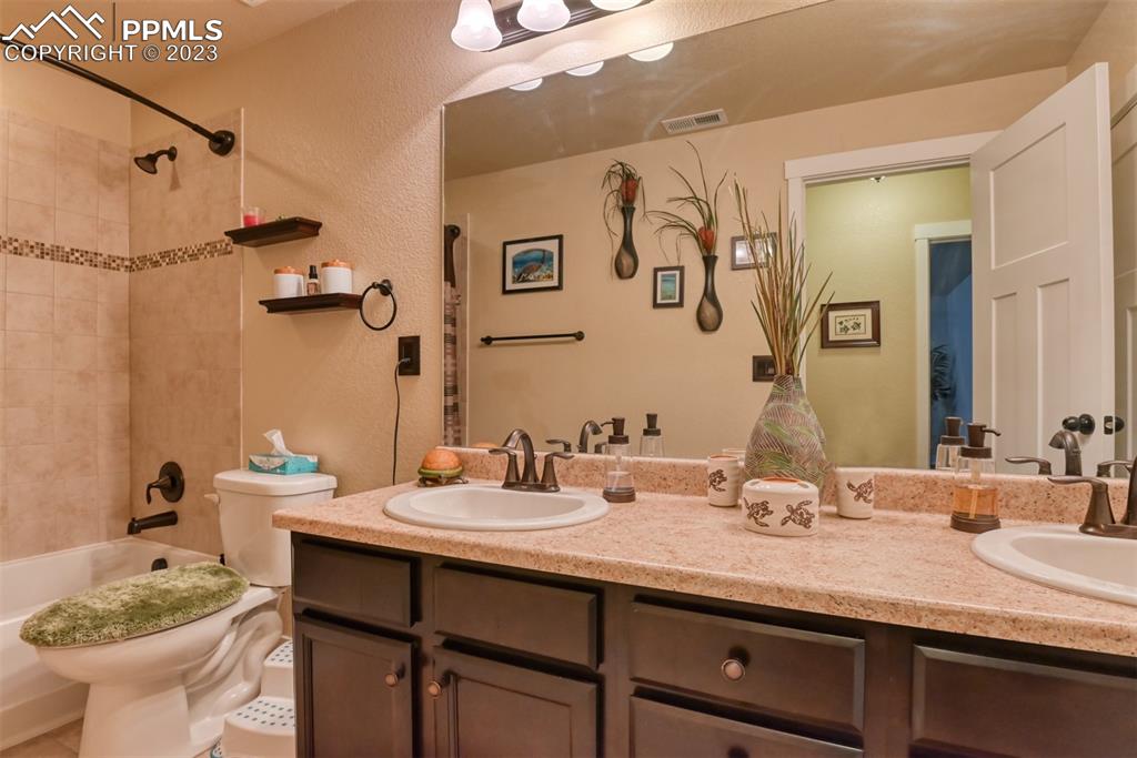 9785 Terrain Road Fountain, CO 80817 - Photo 30 of 40 a bathroom with a granite countertop sink and a mirror