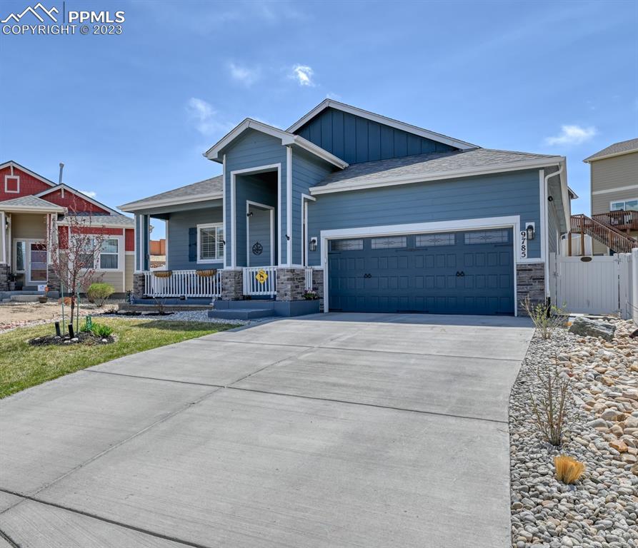 9785 Terrain Road Fountain, CO 80817 - Photo 3 of 40 a front view of a house with a yard and garage