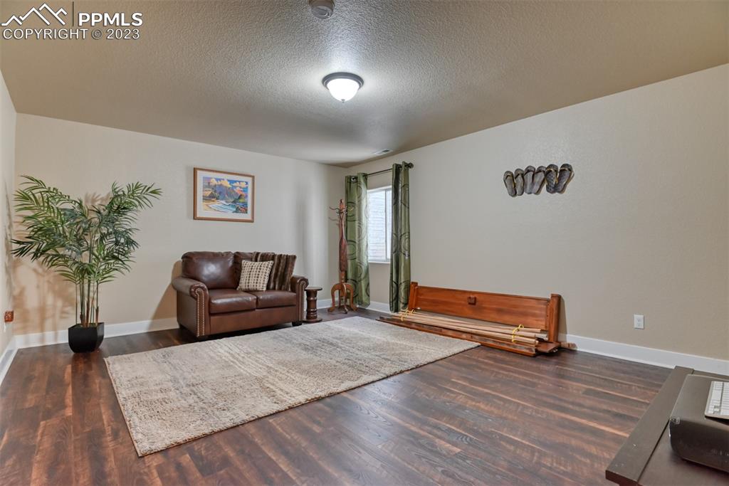 9785 Terrain Road Fountain, CO 80817 - Photo 32 of 40 a living room with furniture and a wooden floor