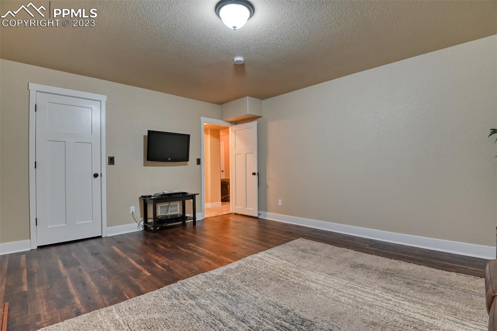 9785 Terrain Road Fountain, CO 80817 - Photo 33 of 40 a view of empty room with wooden floor and furniture