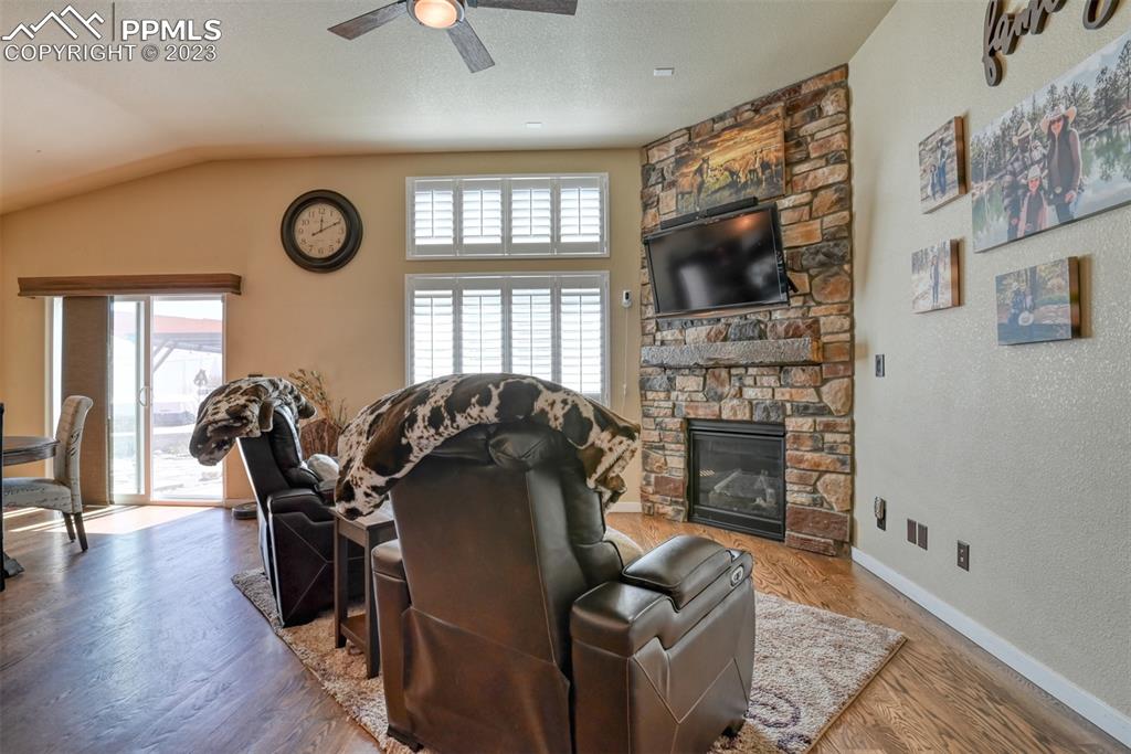 9785 Terrain Road Fountain, CO 80817 - Photo 5 of 40 a living room with furniture a flat screen tv and a fireplace