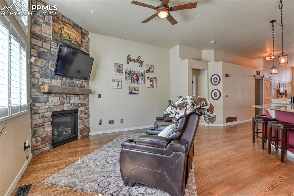 9785 Terrain Road Fountain, CO 80817 - Photo 6 of 40 a living room with furniture a flat screen tv and a fireplace