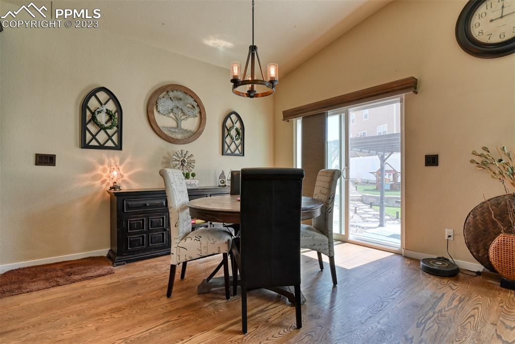 9785 Terrain Road Fountain, CO 80817 - Photo 7 of 40 a view of a dining room with furniture window and wooden floor