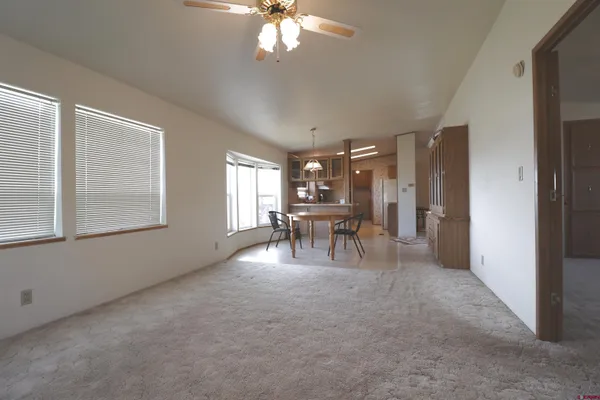a view of a livingroom with furniture and a window