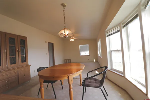 a view of a dining room with furniture and window