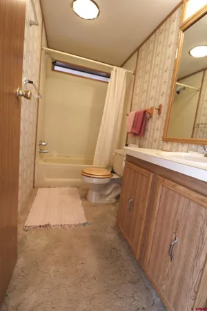 a bathroom with a tub and a shower curtain