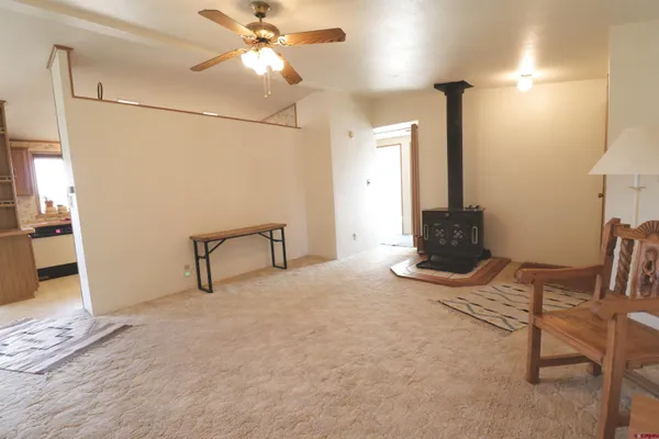 a view of a livingroom with furniture and a ceiling fan
