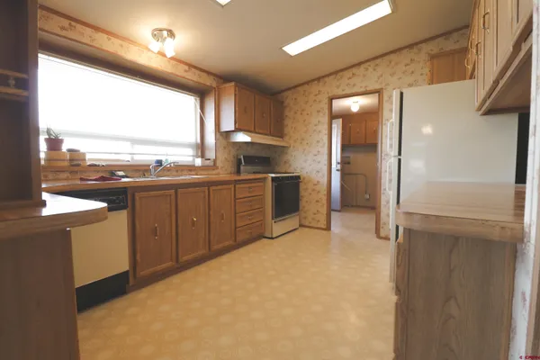 a kitchen with stainless steel appliances a refrigerator and a sink