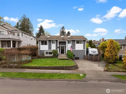 a front view of a house with a garden and outdoor seating