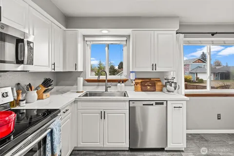 a kitchen with stainless steel appliances granite countertop a stove and cabinets