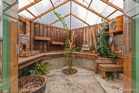 a view of a backyard with plants and a patio