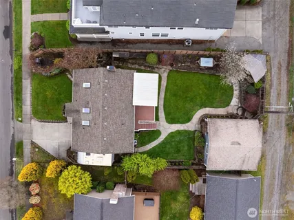 an aerial view of a house with a garden and lake view