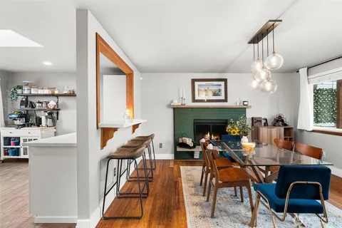 a view of a dining room with furniture window and wooden floor