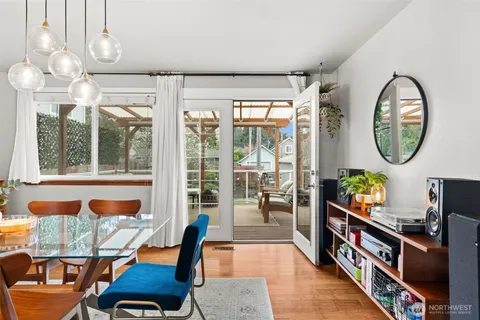 a living room with furniture a chandelier and a large window