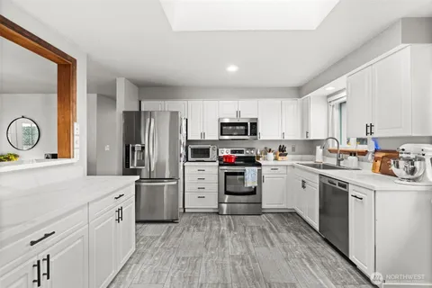 a kitchen with stainless steel appliances a refrigerator stove and sink