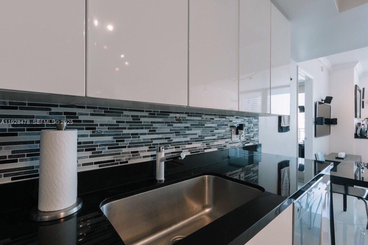 92 Southwest 3rd Street, Unit 1512 Miami, FL 33130 - Photo 2 of 15 a kitchen with a sink and cabinets