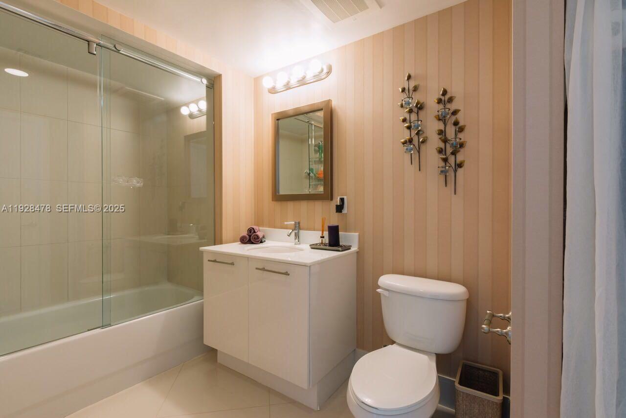 92 Southwest 3rd Street, Unit 1512 Miami, FL 33130 - Photo 3 of 15 a bathroom with a toilet sink and mirror