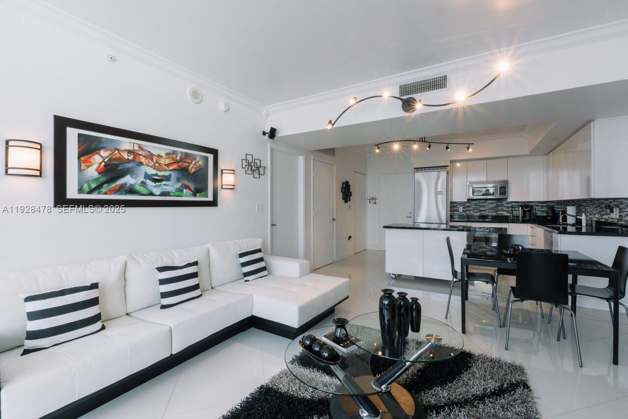 92 Southwest 3rd Street, Unit 1512 Miami, FL 33130 - Photo 5 of 15 a living room with furniture and kitchen view