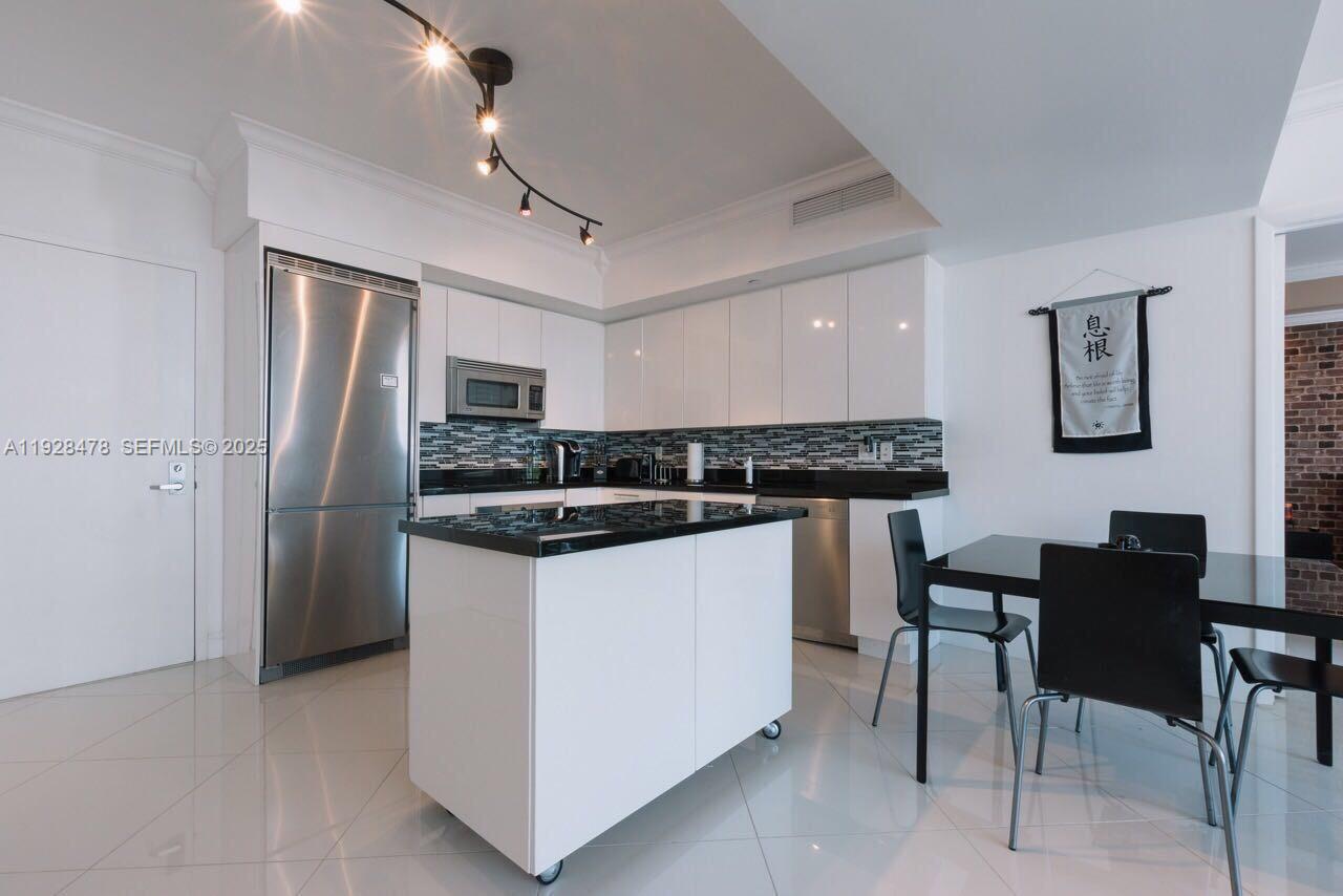 92 Southwest 3rd Street, Unit 1512 Miami, FL 33130 - Photo 10 of 15 a kitchen with stainless steel appliances granite countertop a refrigerator and a stove top oven