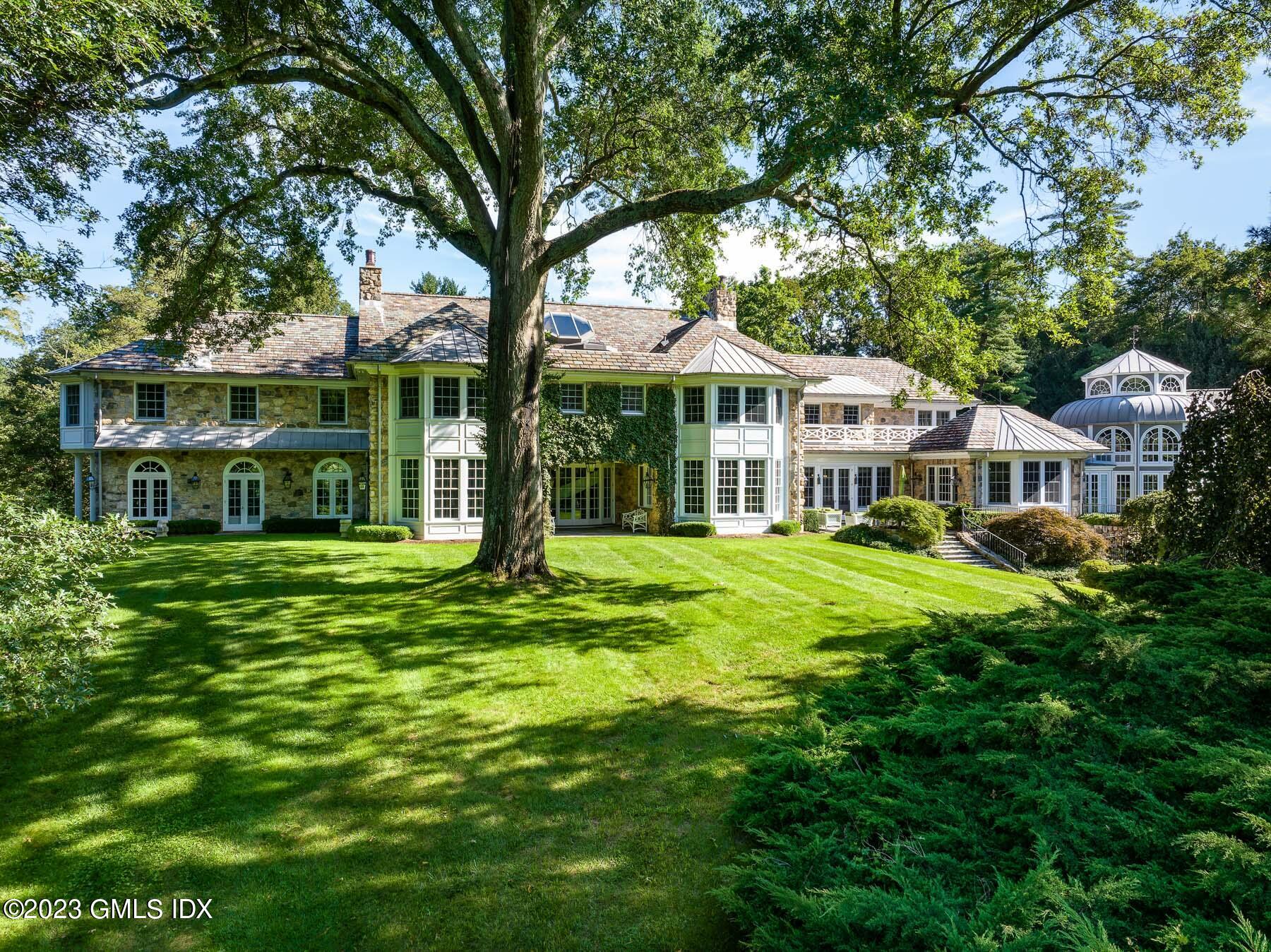 50 Dingletown Road Greenwich, CT 06830 - Photo 32 of 35 a front view of a house with a garden