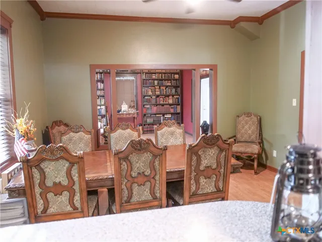 a view of a hallway with windows and stairs