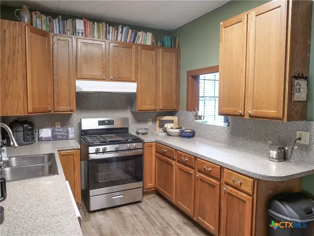 a view of staircase with railing and white walls